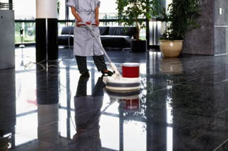 staff cleaning the lobby with floor cleaner machine