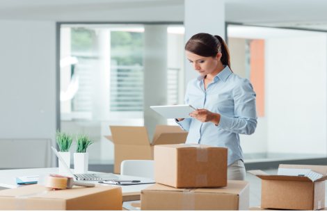 woman packing up her office in cardboard boxes