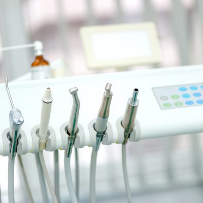 Dental tools on a dentist's chair with white background